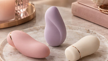 Three small smooth abstract pastel wellness devices in blush