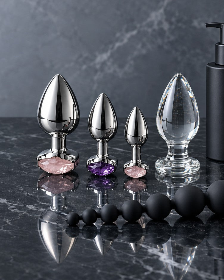 Steel and glass jewel-base plugs and silicone beads on black marble